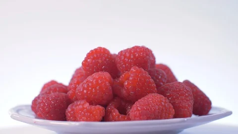 Raspberries Rotating over white Background with slight Zoom in, Raspberries Video stock 127910325