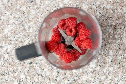 Raspberries in smoothie blender. Top view. Creative photo. Stock Photos