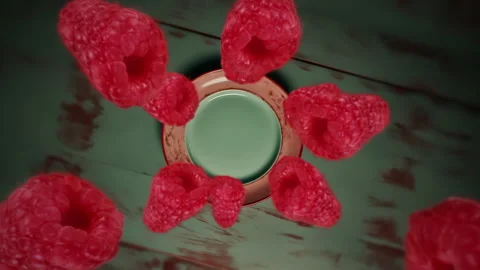 Raspberries spiraling and falling down onto a plate slow motion Video stock 258479861