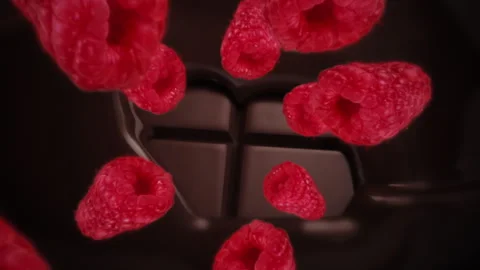 Raspberries spiraling and falling on a melting dark chocolate bar slow motion Stock Footage 258523267