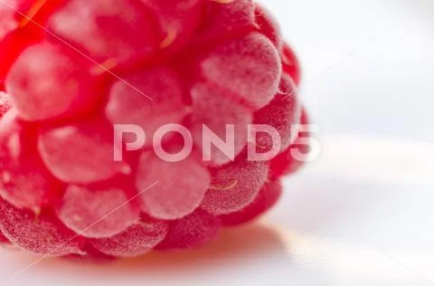 Raspberries on a white saucer close up, macro photo Stock Photos