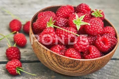 Raspberries in wooden bowl Stock Photos