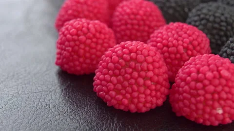 Raspberry and blackberry shaped gummy candies on textured surface. Macro. Rot Stock Footage 170822689