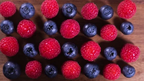 Raspberry and blueberry berries close up. Healthy nutrition. Stop motion. Stock Footage 119640516