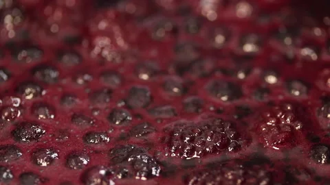 The raspberry and blueberry sauce is bubbling in the pot.  動画素材 141930394