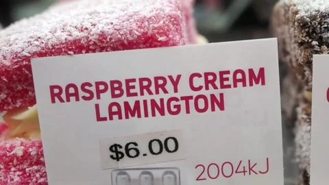 Raspberry and Chocolate Cream Lamingtons displayed for sale Stock Footage 338265759