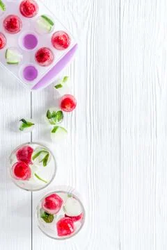 Raspberry and lime in ice cubes on white table top view copy space Stock Photos