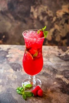 Raspberry and Mint Mojito with lemon slice served in cocktail glass isolate.. Stock Photos