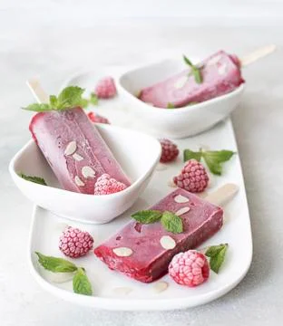 Raspberry and mint popsicles with frozen berries and fresh mint Stock Photos