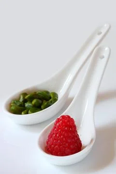 Raspberry and pistachios Stock Photos