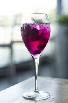 Raspberry and red dragon fruit prosecco wine spritzer cocktail Stock Photos