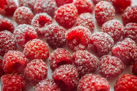 Raspberry berries on a white background. A portion of the ripe berries powd.. Stock Photos