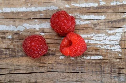 Raspberry berries on a wooden surface. Stock Photos