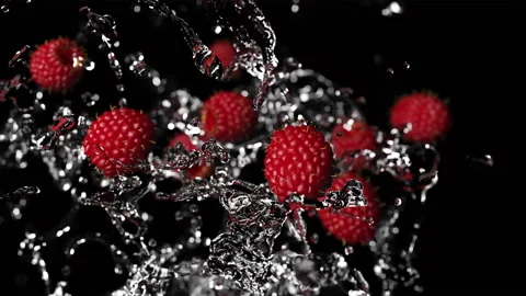Raspberry berry on a black background in slow motion falling with water drops Stock Footage 160236898