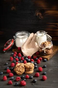 Raspberry, biscuits and milk, flour jars with copyspace above Stock Photos