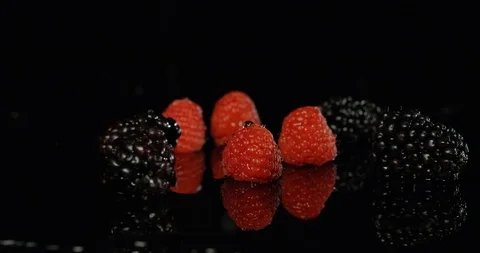 Raspberry Blackberry and Blueberry falling in water Stock Footage 101600469