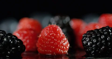 Raspberry Blackberry and Blueberry falling in water Stock Footage 101600810
