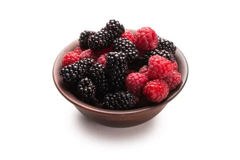 Raspberry, blackberry and mint leaf in ceramic brown bowl isolated on white Stock Photos