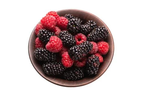Raspberry, blackberry and mint leaf in ceramic brown bowl isolated on white Stock Photos