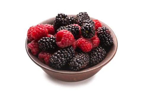 Raspberry, blackberry and mint leaf in ceramic brown bowl isolated on white Stock Photos