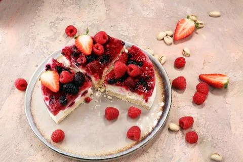 Raspberry cake and many fresh raspberries Stock Photos