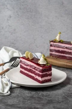 Raspberry cake on a dark background. Layered raspberry cake slice. Bakery cak Stock Photos