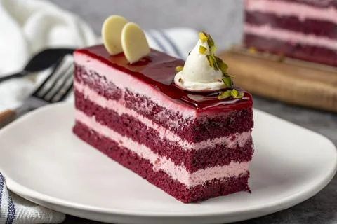 Raspberry cake on a dark background. Layered raspberry cake slice. Bakery cak Stock-Fotos