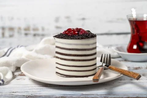Raspberry cake. Delicious chocolate covered cake on a white background. Close Stock Photos
