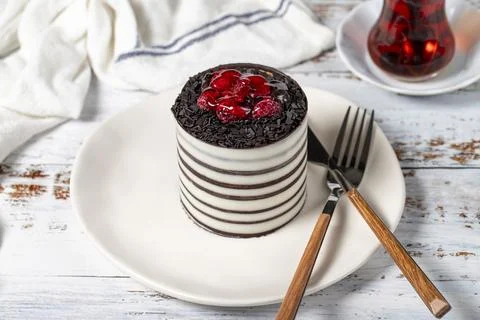 Raspberry cake. Delicious chocolate covered cake on a white background. Stock Photos