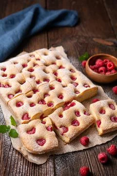 Raspberry cake known as Bublanina sprinkled with powdered sugar Stock Photos