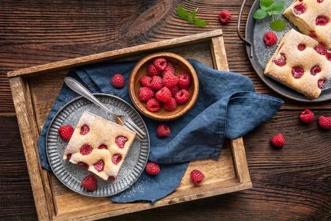 Raspberry cake known as Bublanina sprinkled with powdered sugar Stock Photos