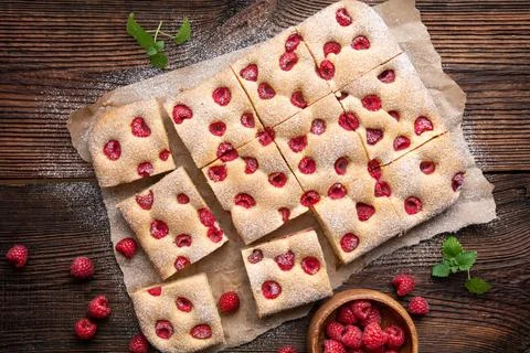 Raspberry cake known as Bublanina sprinkled with powdered sugar Stock Photos