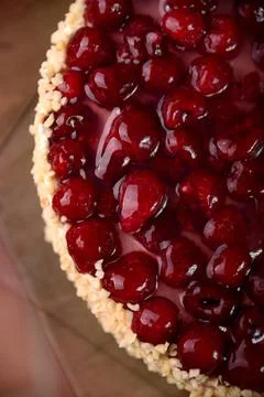 Raspberry cake with nuts on wooden table Stock Photos