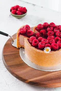 Raspberry Cake With Slice On Wooden Board Фото