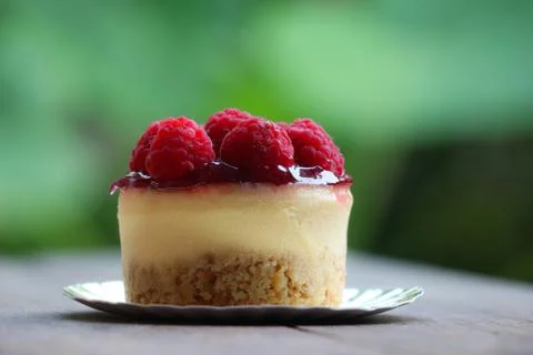Raspberry cheese cake sweet bake topping with fruit on wood background Stock Photos