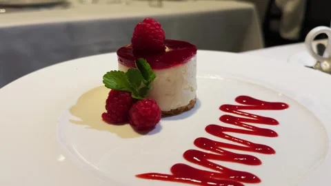 Raspberry cheesecake served with berries and mint. Delicious delicate dessert. Stock Footage 315341194