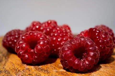 Raspberry close up macro on a gray and wood background. Nature background. Fr Stock Photos