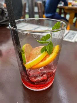 Raspberry cocktail with lime, mint, ice cubes and fresh berries on the table Stock-Fotos