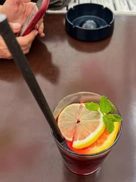 Raspberry cocktail with lime, mint, ice cubes and fresh berries on the table Stock Photos