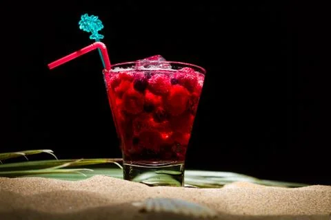 Raspberry cocktail on the sand Stock Photos