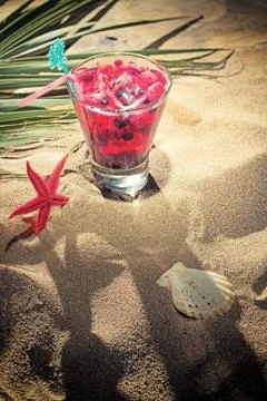 Raspberry cocktail on the sand Stock Photos