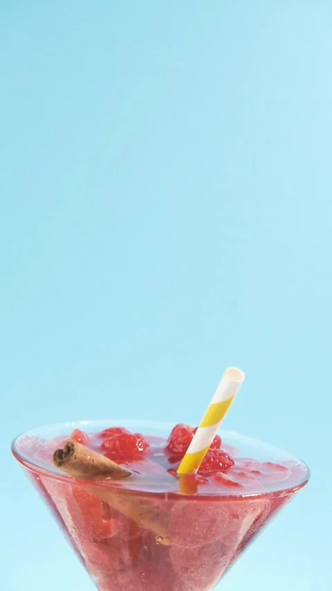 Raspberry cocktail Summer drink on cyan with yellow striped straw Stock Footage 245132737