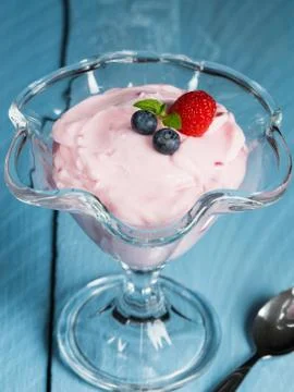 Raspberry cream dessert with mint and fruits Stock Photos