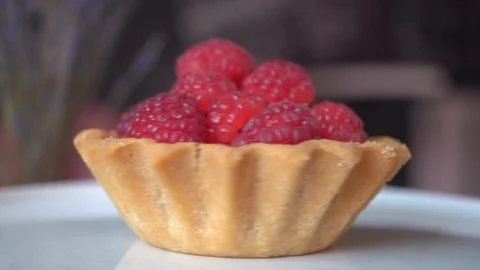 Raspberry custard cake in a basket of sand dough rotates on a white plate Stock Footage 117777821