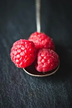 Raspberry on a dark background. Summer and healthy food concept. Background w Stock Photos