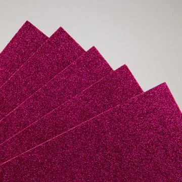 Raspberry, dark pink glitter craft foam sheets background. Stock Photos