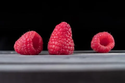 Raspberry on a dark wooden background Stock Photos