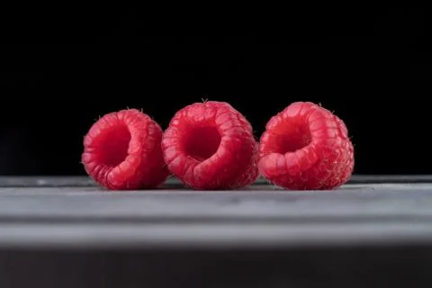 Raspberry on a dark wooden background Stock Photos
