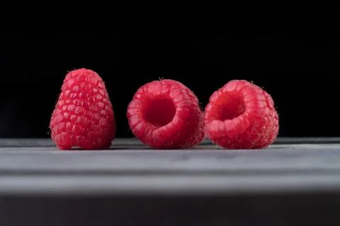 Raspberry on a dark wooden background Stock Photos