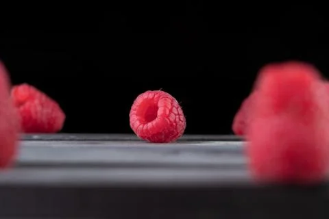 Raspberry on a dark wooden background Stock Photos